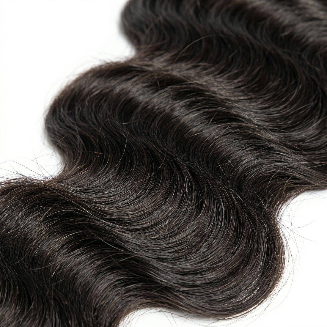 Black hair extensions with wavy texture on a white background