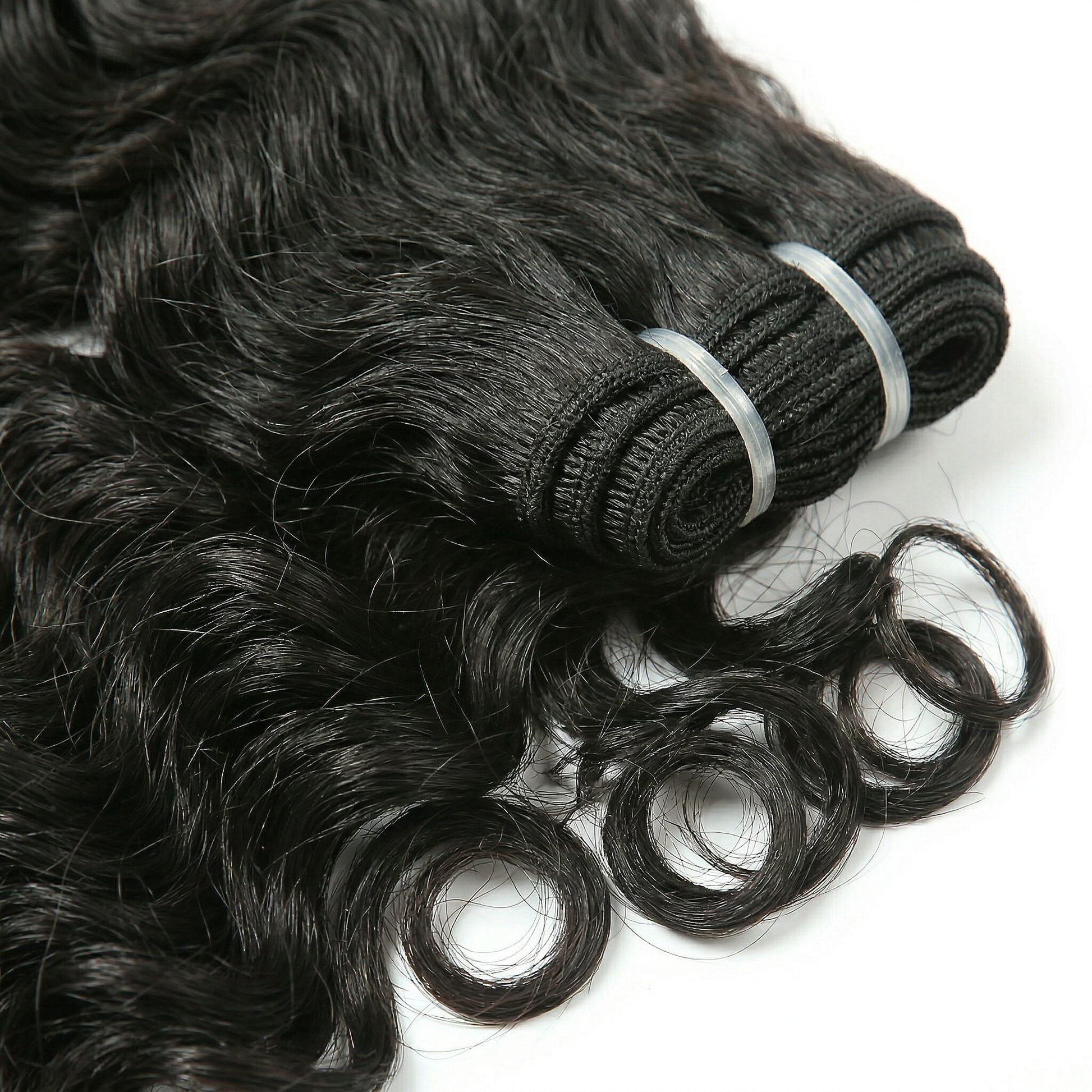 Three bundles of black loose wave hair extensions on a white background